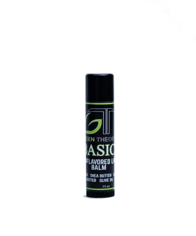 Photo of the front of green theory all natural basic lip balm. Product is in sleek blacl plastic container with a label wrapped around the stick. Product is standing on the dial against a white background. Under the green theory logo is the name Basic with "unflavored lip balm and then the ingredients 