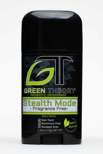 front view photo of Green Theory Stealth Mode unscented probiotic aluminum free natural deodorant. Stick is a sleek black plastic container standing against a pure white background. Front label feature the large GT green theory logo with the G being stylized in the shape of a leaf superimposed over a faded camouflage pattern. "Stealth Mode" is written in an army style font with "fragrance free" written below it. "non toxic", "aluminum free" and "paraben free" are listed as product benefits on the bottom