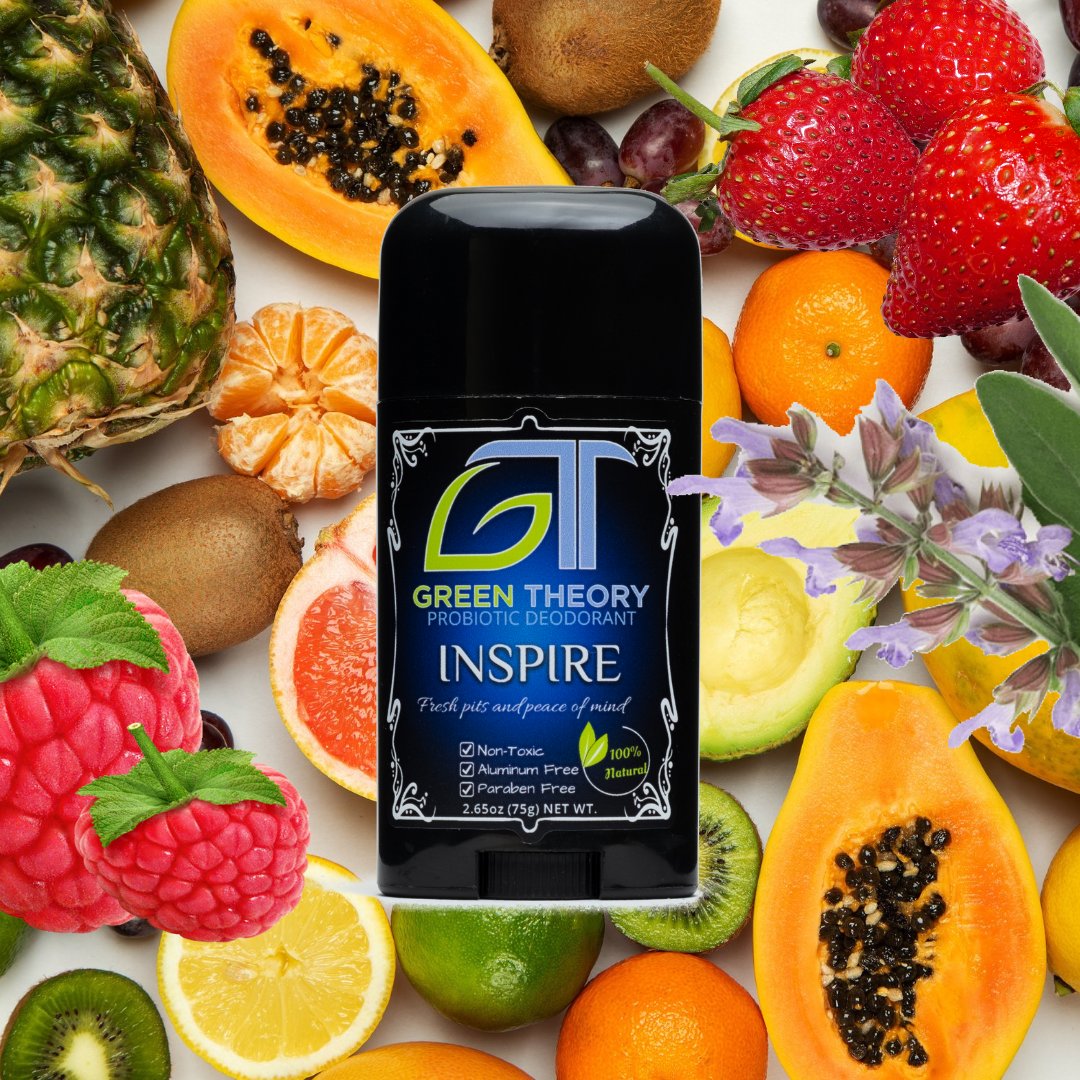 Image of Green Theory Inspire deodorant for women. Product is overlayed on top of an image featuring many different fruits to show the fruity scent. Product label features large GT green theory logo above the words "probiotic deodorant" and "inspire".