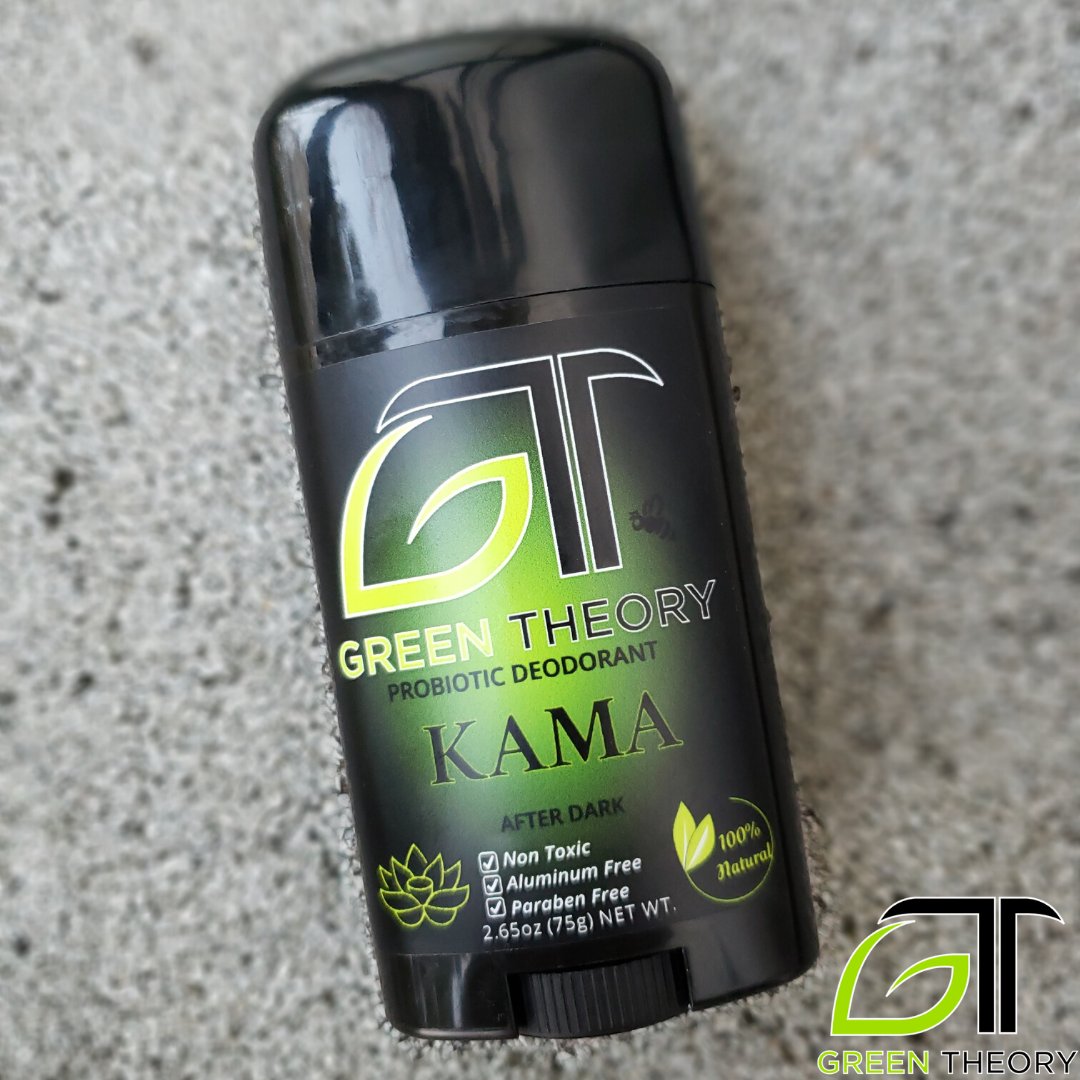 Photo of Green Theory Kama probiotic deodorant for men laying on grainy roofing texture that is blurred out.