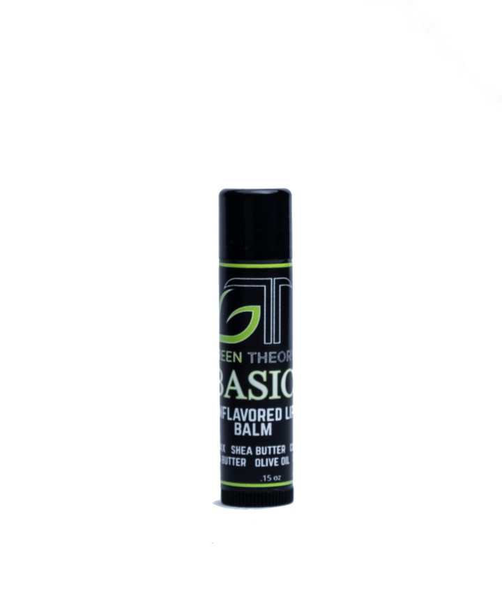 Photo of the front of green theory all natural basic lip balm. Product is in sleek blacl plastic container with a label wrapped around the stick. Product is standing on the dial against a white background. Under the green theory logo is the name Basic with "unflavored lip balm and then the ingredients 