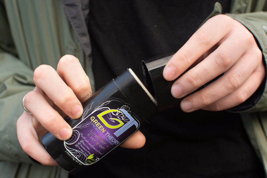 woman removing the cap from green theory lavender and evergreen aluminum free deodorant for women