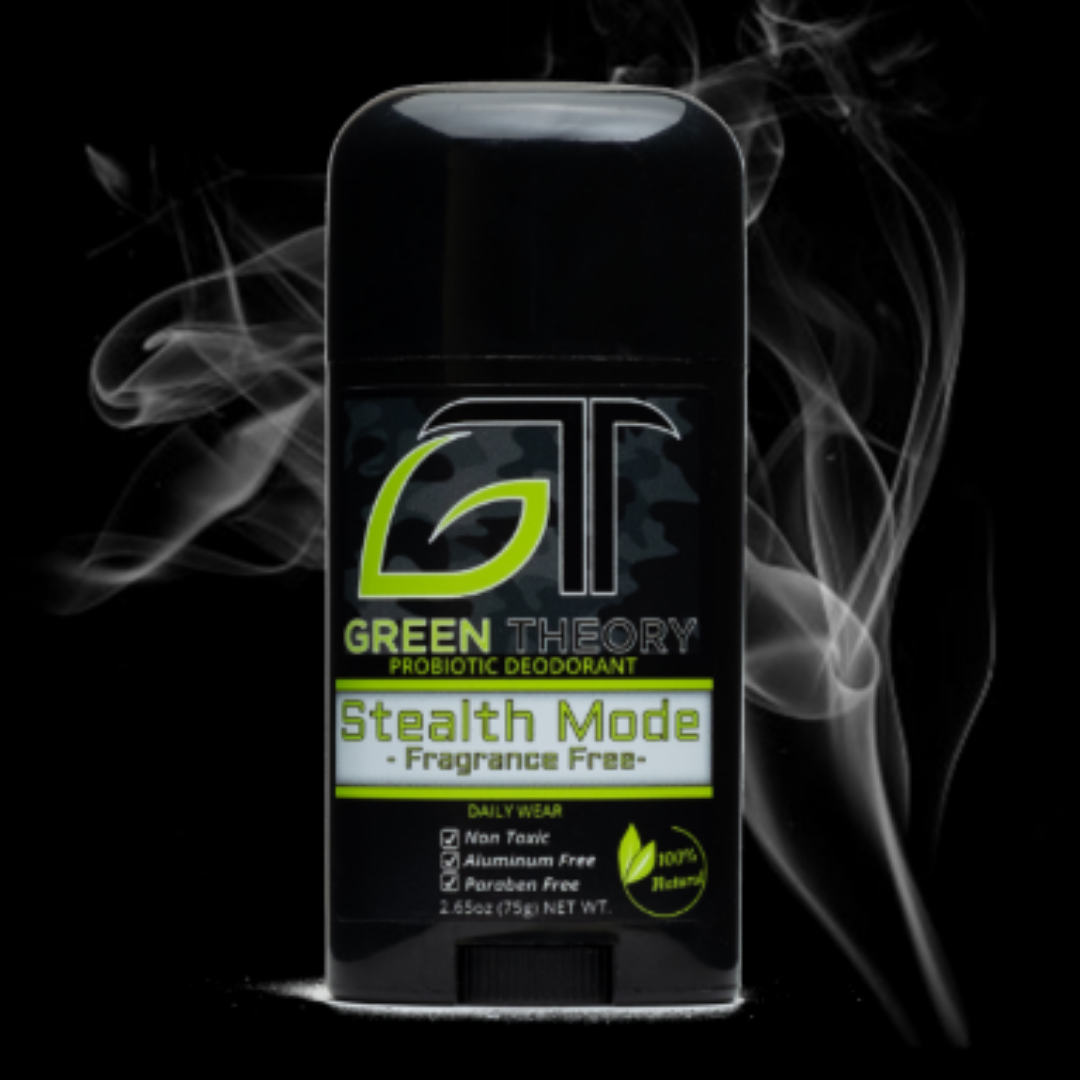 photo of green theory stealth mode fragrance free probiotic aluminum free deodorant over black background with smoke rising behind it