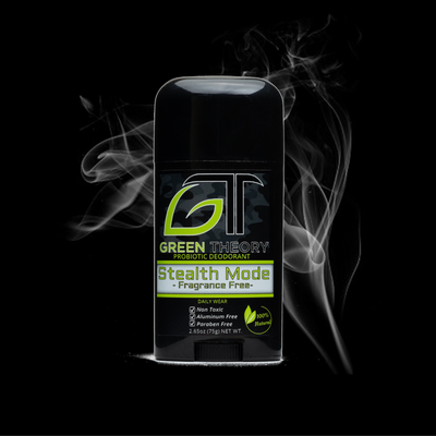 photo of green theory stealth mode fragrance free probiotic aluminum free deodorant over black background with smoke rising behind it