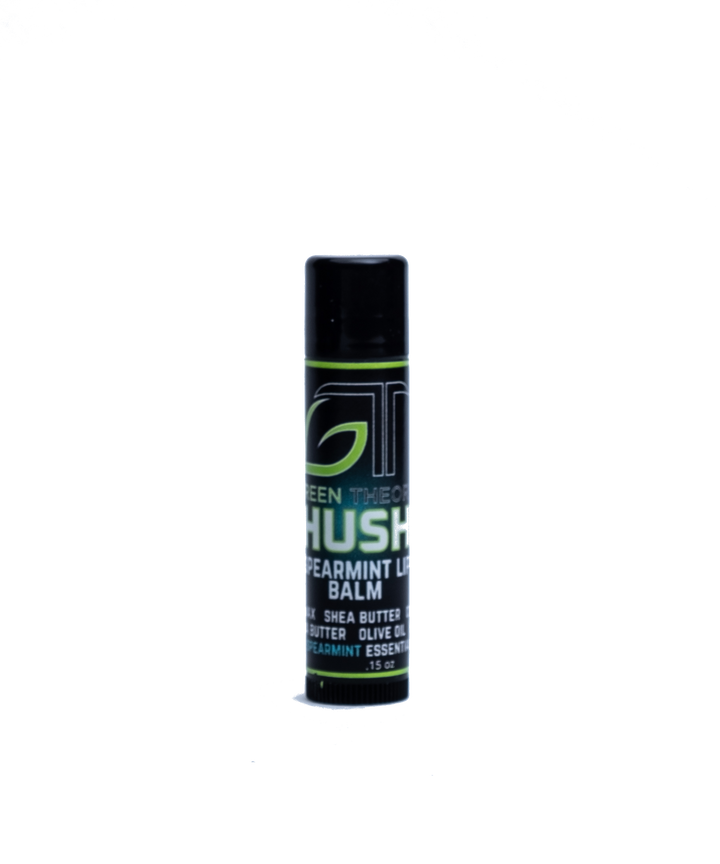 photo of green theory hush all natural lip balm against an all white background. Container is a sleek black plastic and is standing upright. Label features a large GT Green Theory logo with "hush" written over a teal orb. "Spearmint lip balm" is below "hush" and the list of ingedients is at the bottom
