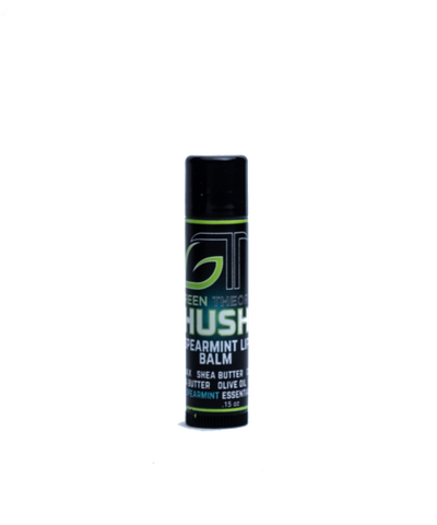 photo of green theory hush all natural lip balm against an all white background. Container is a sleek black plastic and is standing upright. Label features a large GT Green Theory logo with "hush" written over a teal orb. "Spearmint lip balm" is below "hush" and the list of ingedients is at the bottom