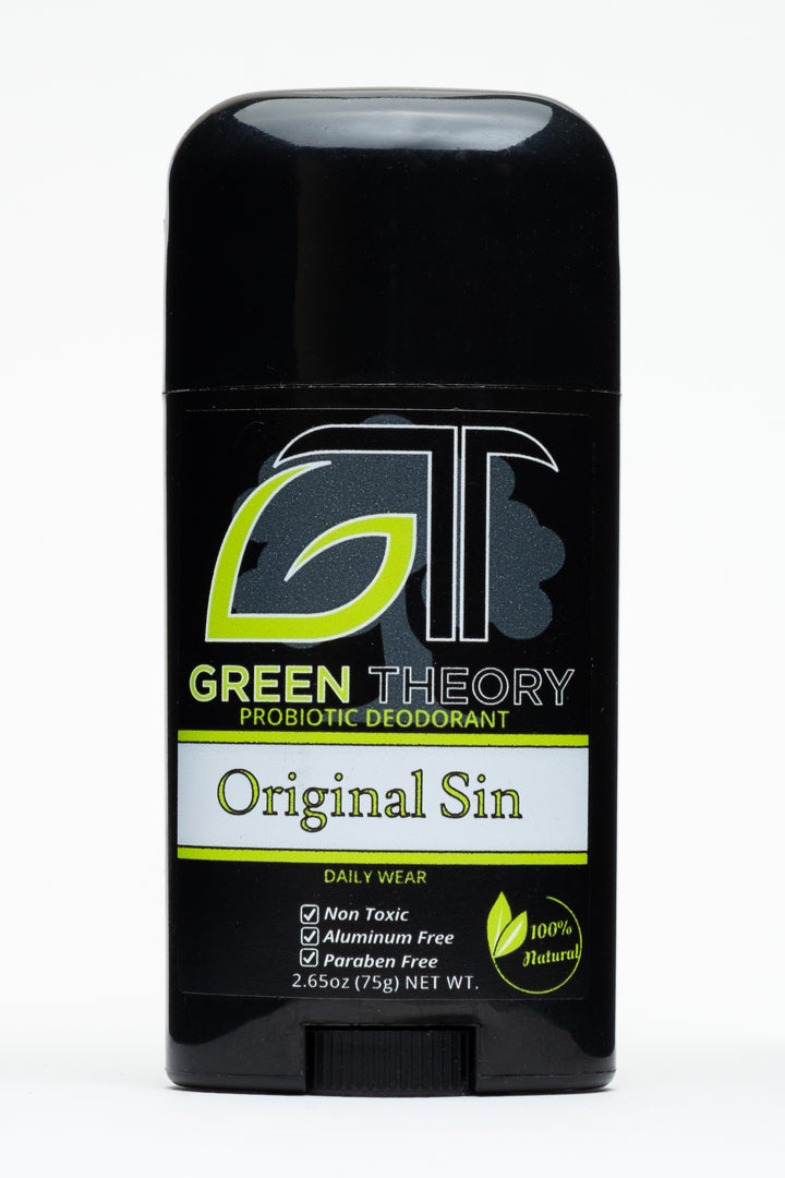 photo of the front of a stick of green theory original sin probiotic aluminum free deodorant for men. Container is a shiny black plastic against a pure white background. The front label from top to bottom features a large GT logo with the G in the shape of a leaf. The logo is superimposed over a grey image of a tree. "original sin" is written in biblical style font with "non toxic", "aluminum free" and "paraben free" listed as product benefits with a "100% natural" graphic in the lower right corner