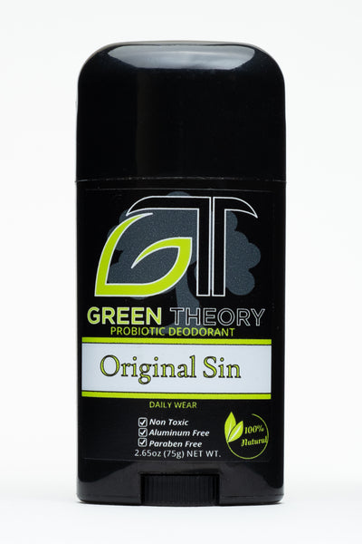 photo of the front of a stick of green theory original sin probiotic aluminum free deodorant for men. Container is a shiny black plastic against a pure white background. The front label from top to bottom features a large GT logo with the G in the shape of a leaf. The logo is superimposed over a grey image of a tree. "original sin" is written in biblical style font with "non toxic", "aluminum free" and "paraben free" listed as product benefits with a "100% natural" graphic in the lower right corner