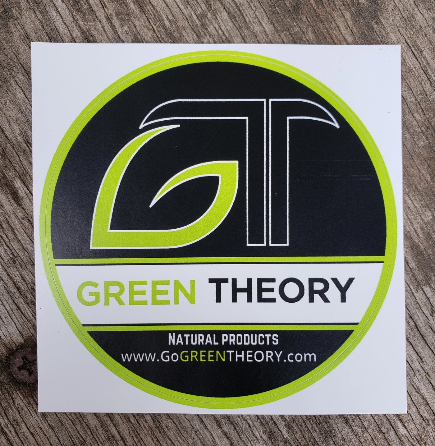 Green Theory black vinyl sticker on wood texture