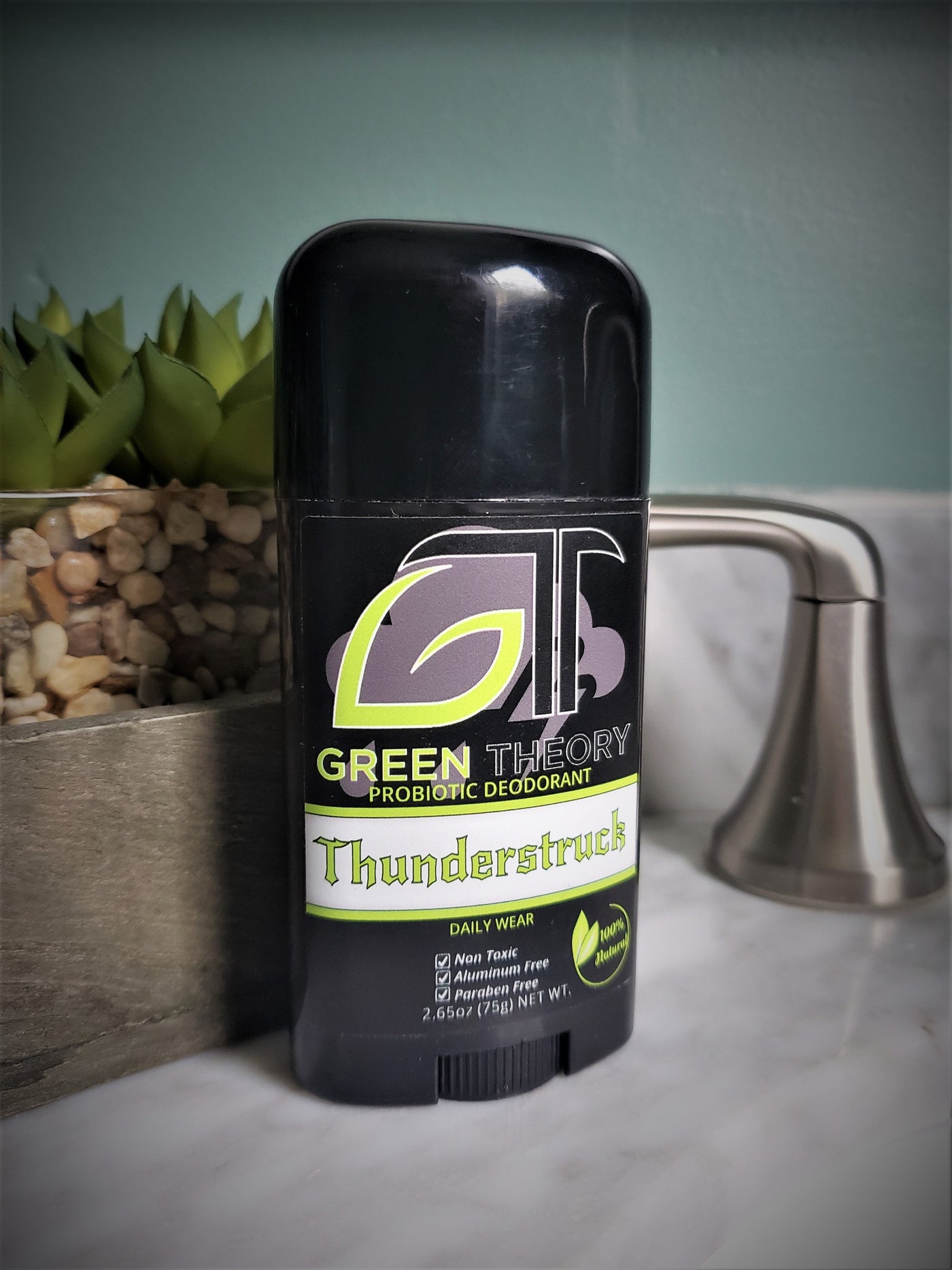 Green Theory Thunderstruck probiotic aluminum free natural deodorant for men sitting on a sink counter in a bathroom